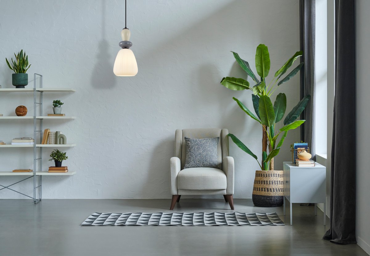 Grey stone wall background room interior concept, sofa, furniture, vase of plant, city view, carpet, decoration modern decor style.